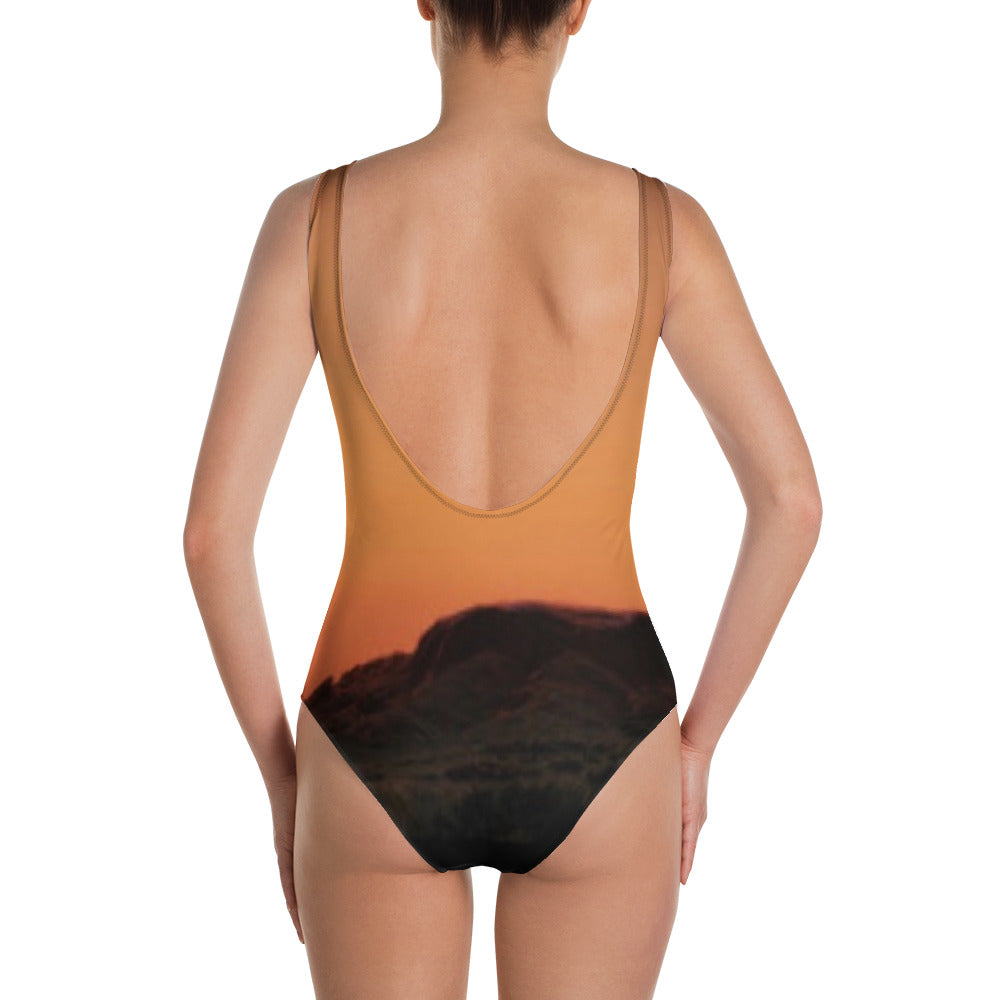 Back view of Mesa swimsuit for women featuring a sunset mountain design and low scoop back