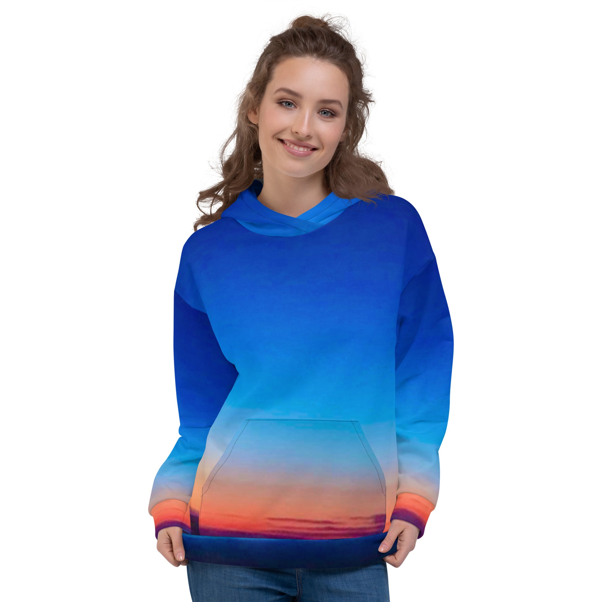 Kallistii skyline hoodie unisex with blue and orange sunset gradient worn by smiling woman