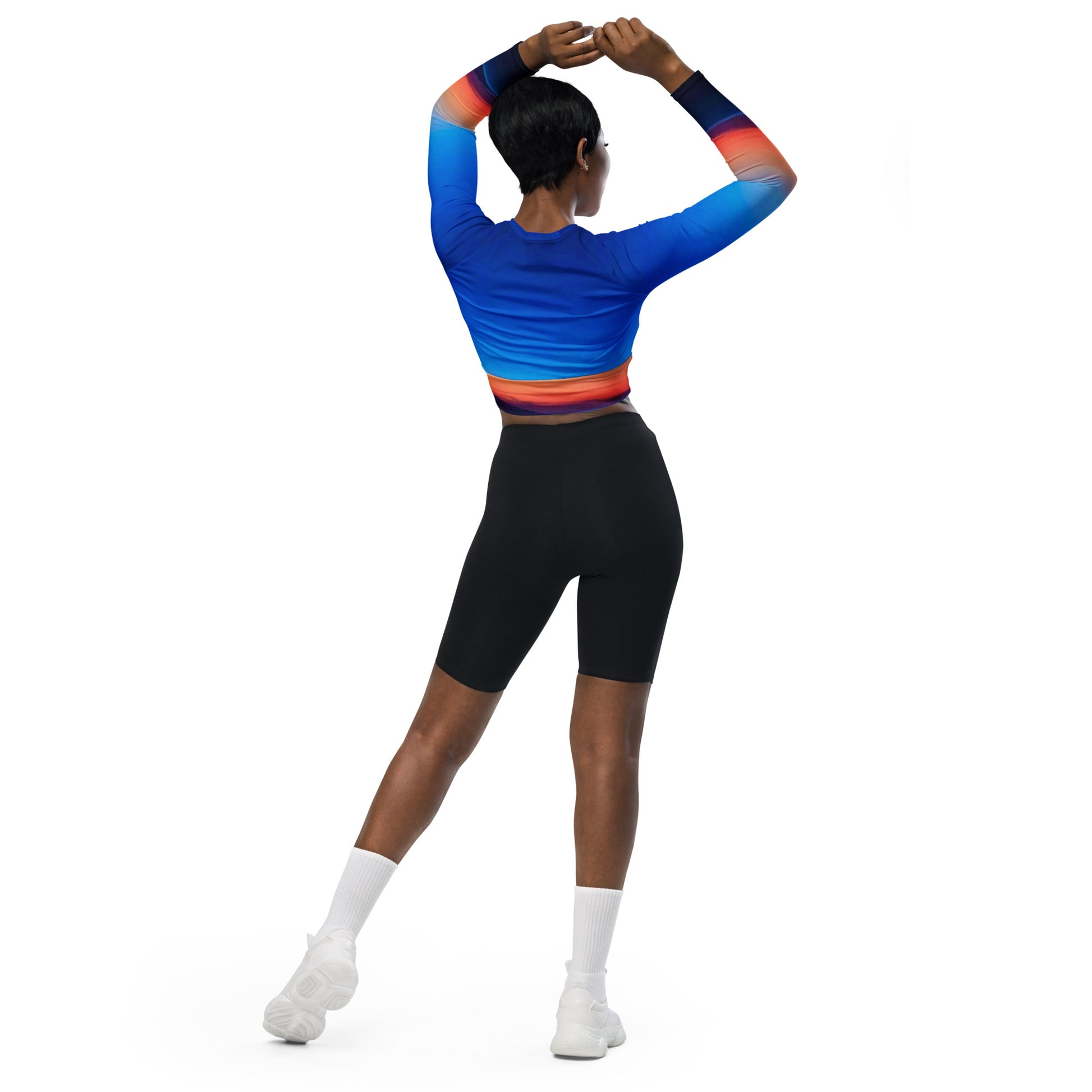 Woman wearing kallistii skyline long-sleeve crop top in blue with red and orange gradient on sleeves