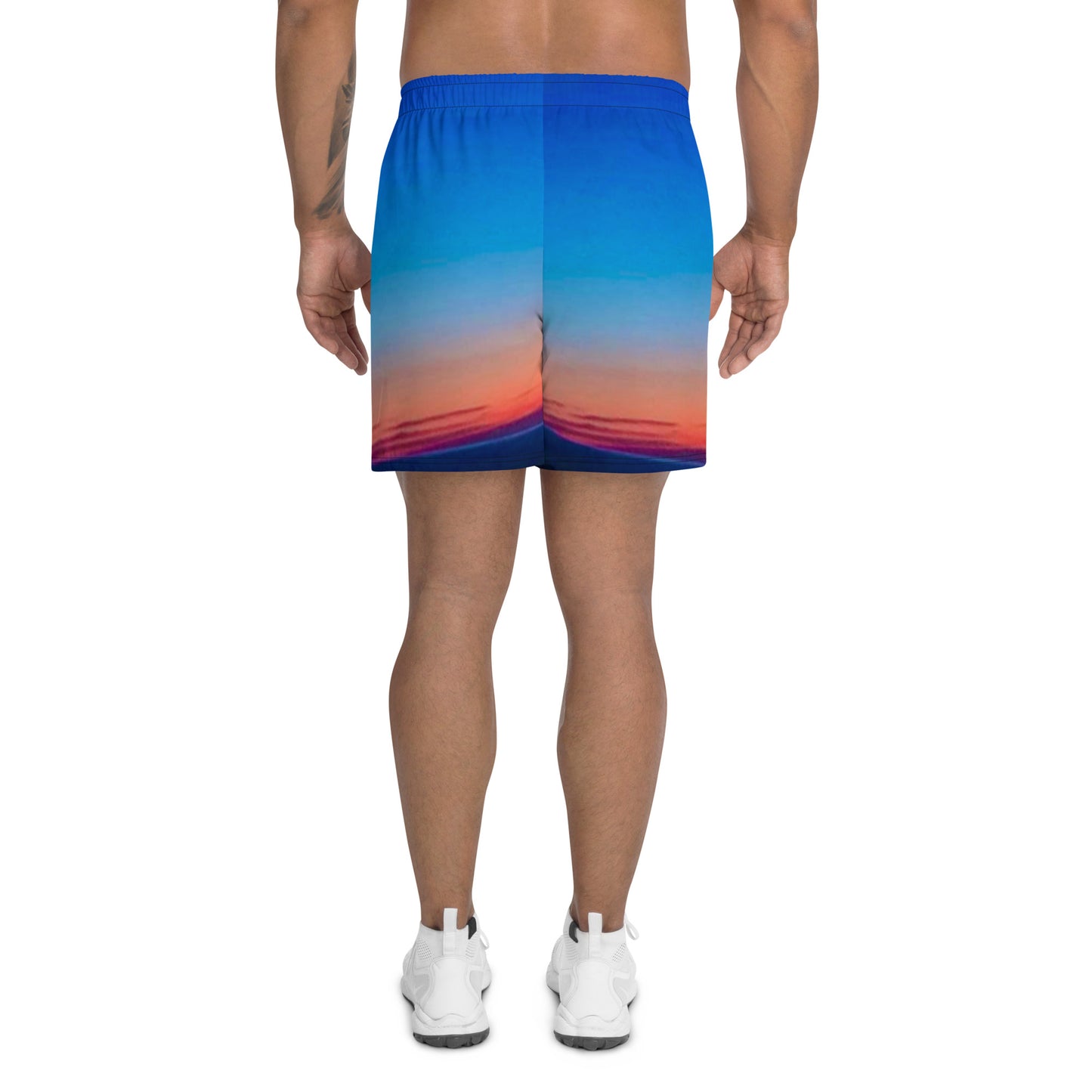 Back view of man wearing kallistii skyline mens athletic shorts with blue and orange sunset gradient design