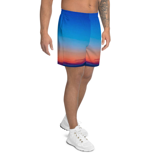 Kallistii skyline mens athletic shorts featuring a blue to orange gradient sunset design worn with white athletic shoes