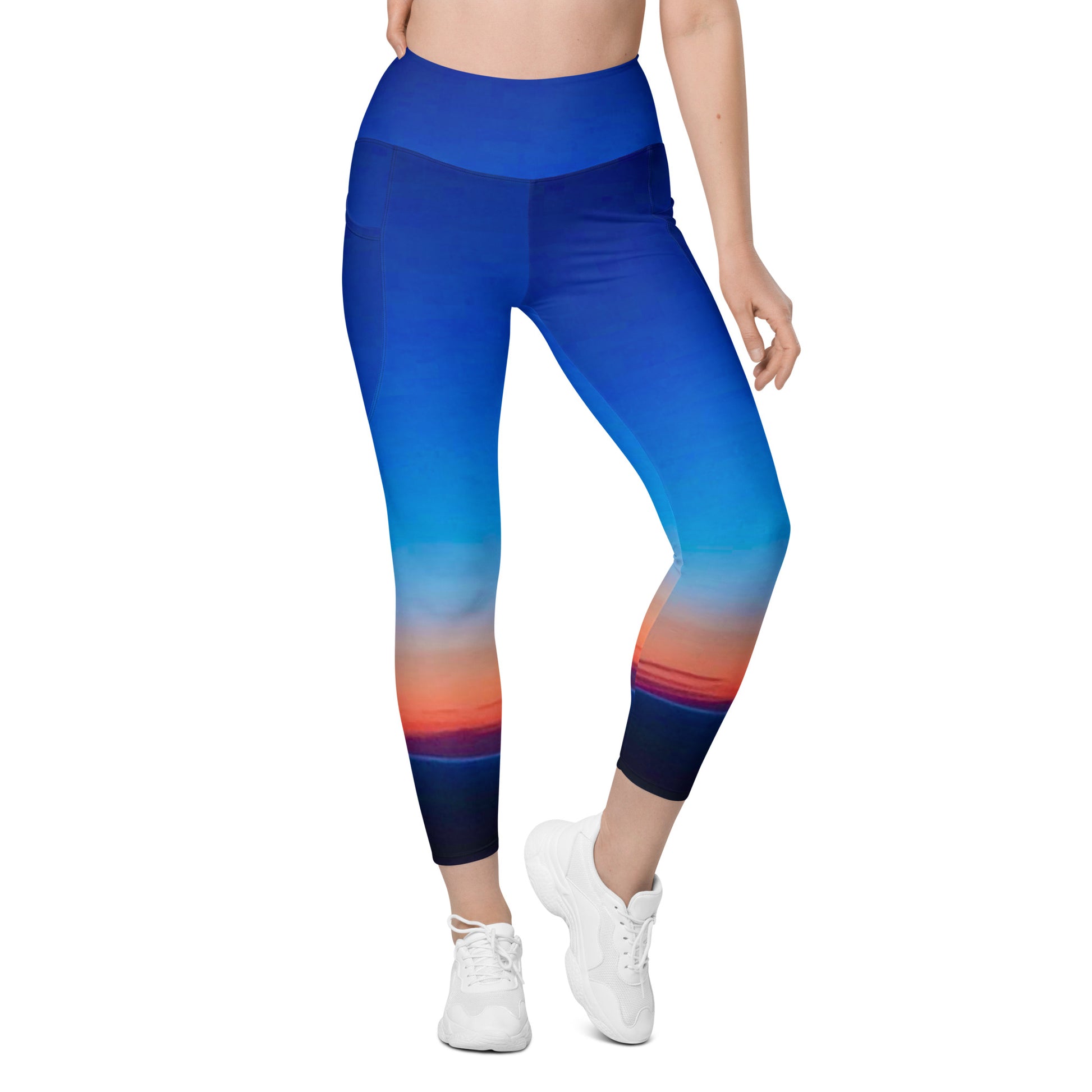 Kallistii skyline print womens leggings with blue and orange gradient design modeled with white sneakers